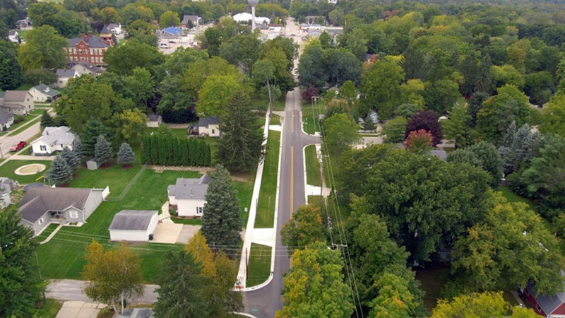 This is an arial view of the Bordman Road construction project with a main road going through a small town.